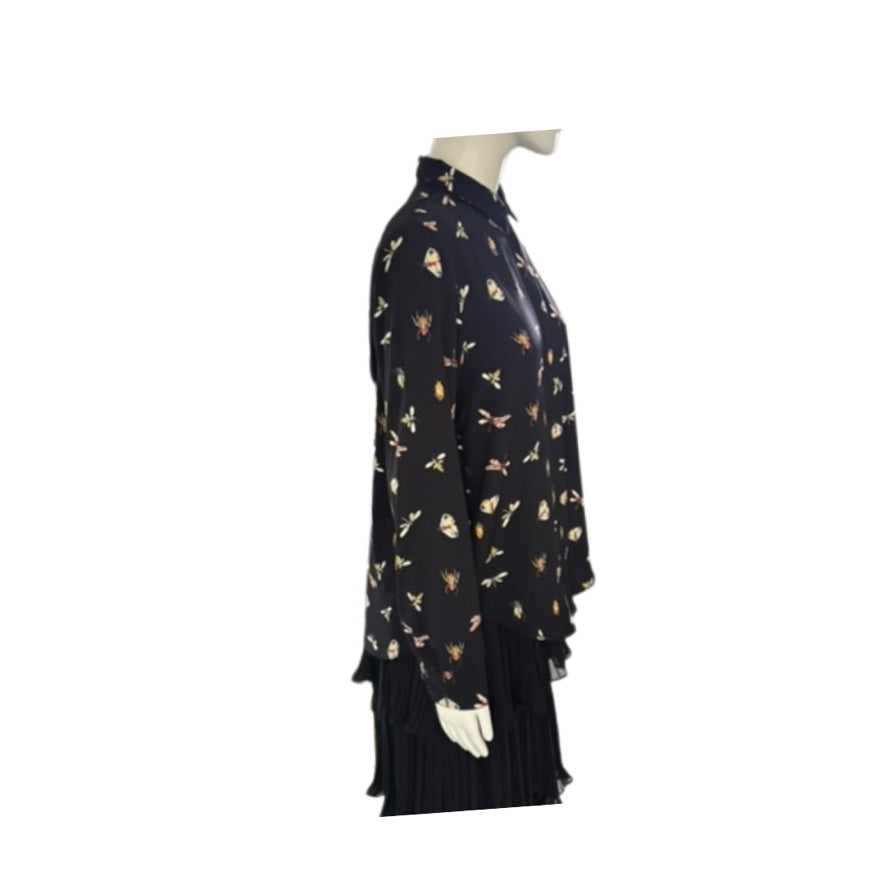 Black dress with floral pattern on a mannequin against a white background