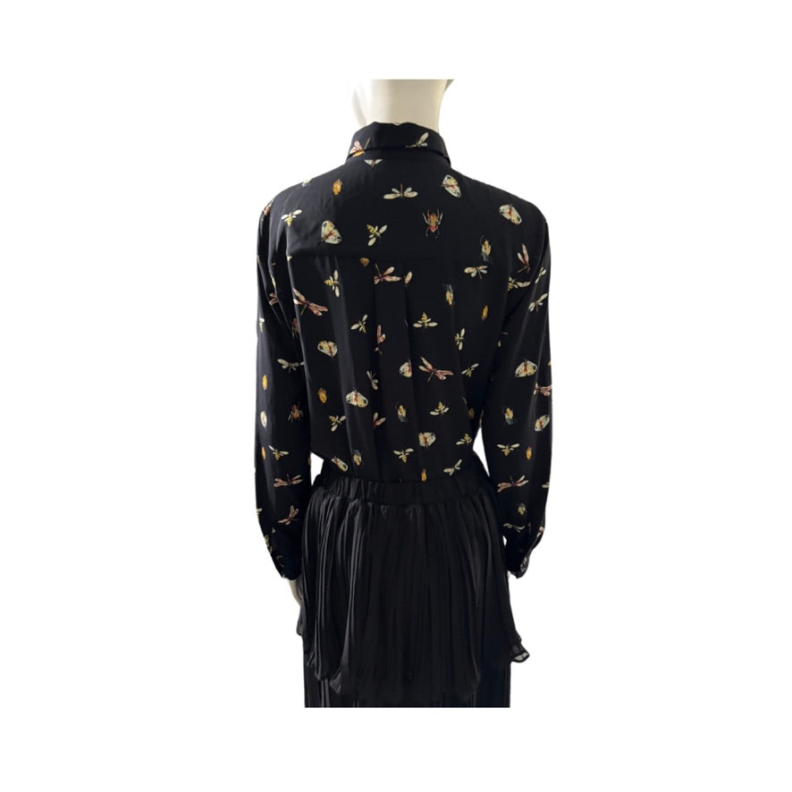 Black dress with gold butterfly pattern on a mannequin against a white background