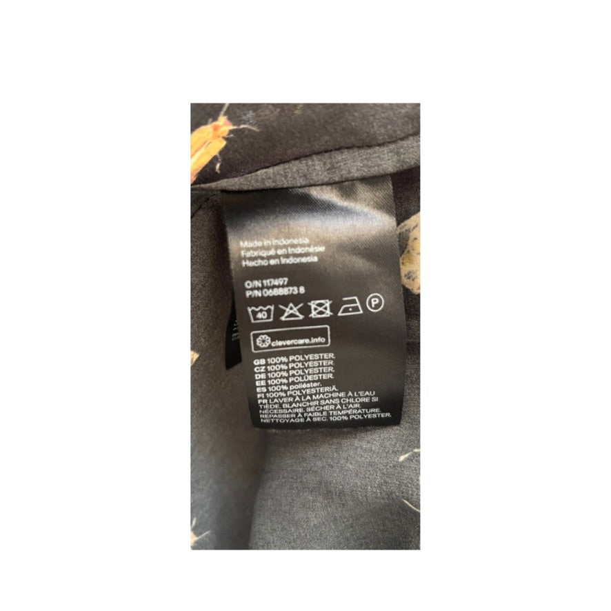 Clothing label with care instructions on a garment with a white background