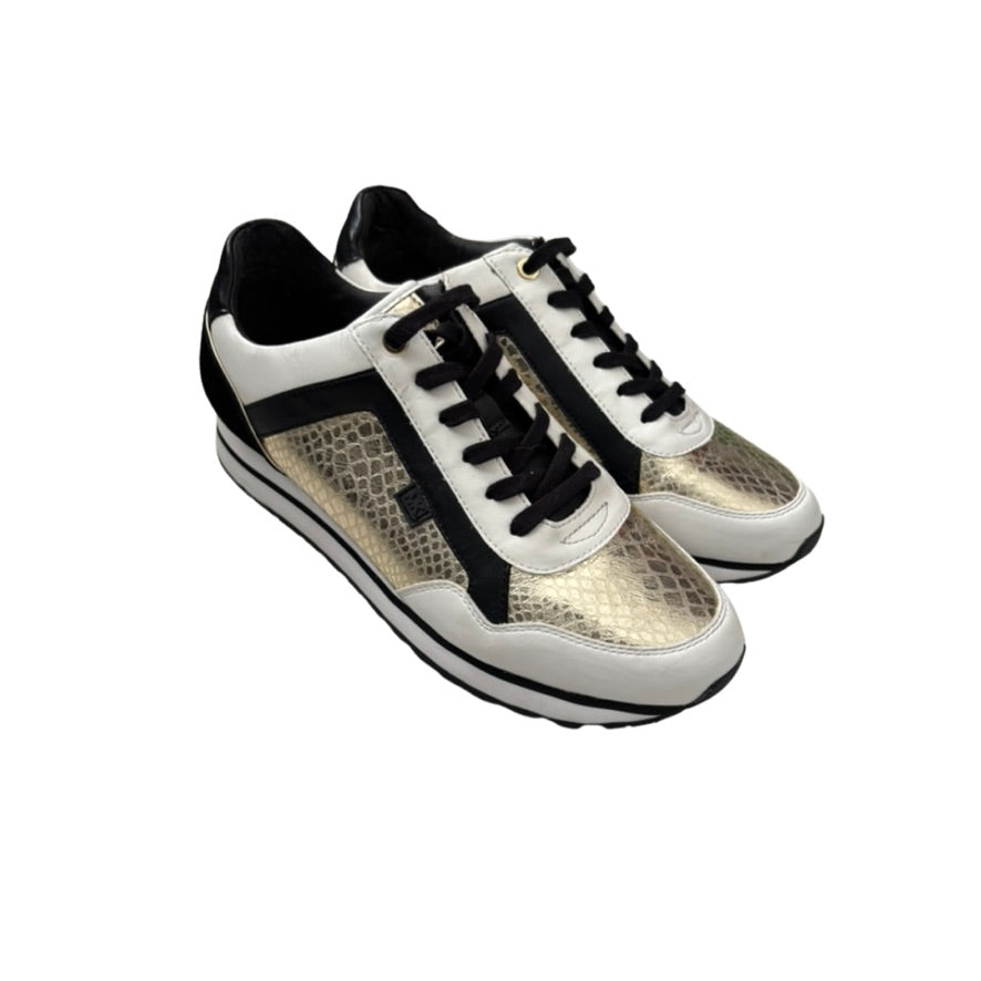 Pair of white sneakers with black accents on a white background