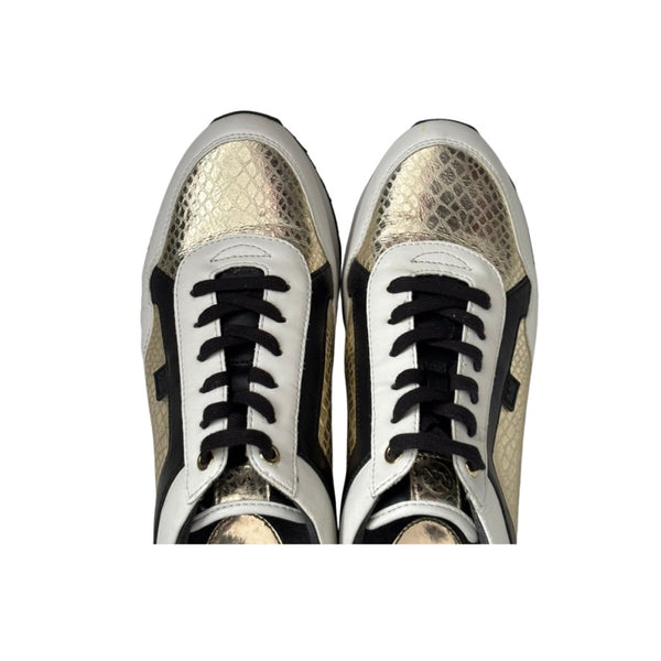 Pair of snakeskin-patterned sneakers with black laces on a white background