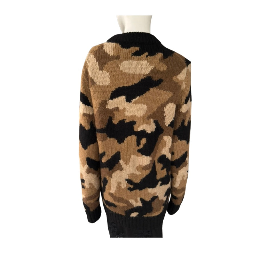 Camouflage-patterned sweater on a mannequin against a white background