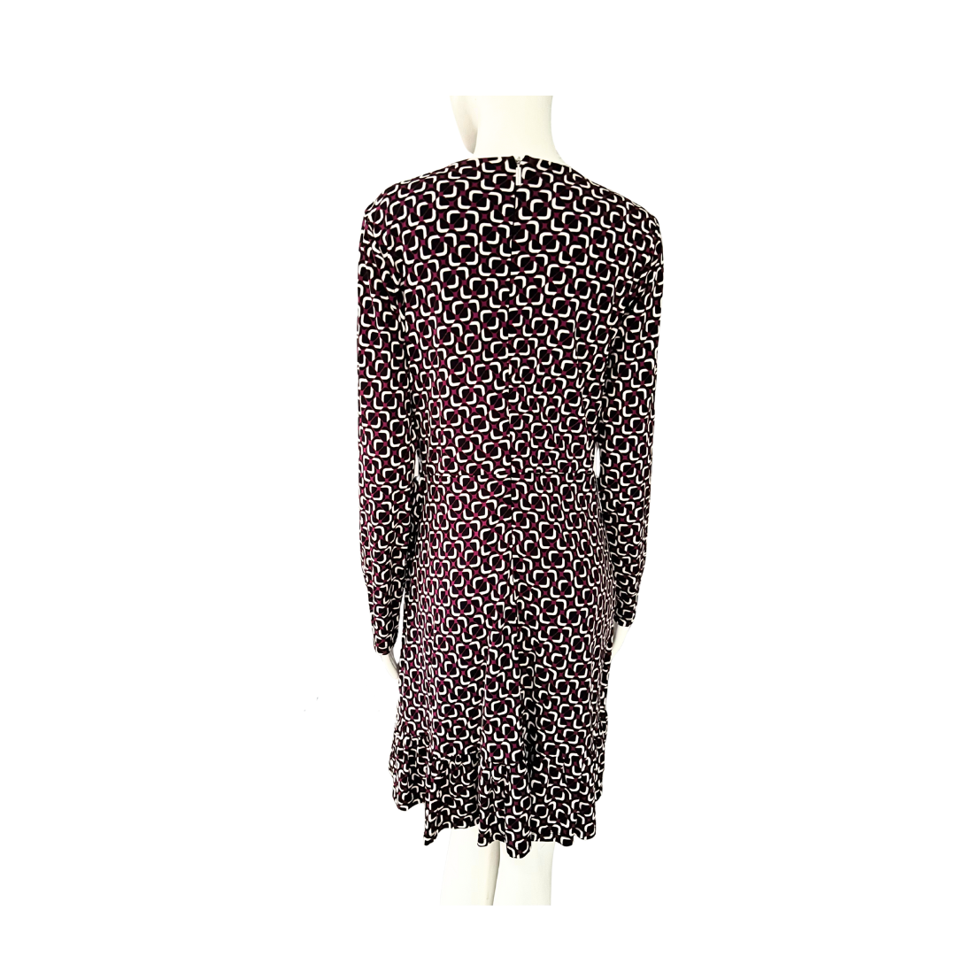 Maroon, black and white patterned dress on a mannequin against a white background