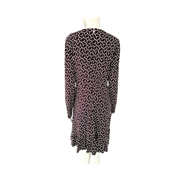 Maroon, black and white patterned dress on a mannequin against a white background