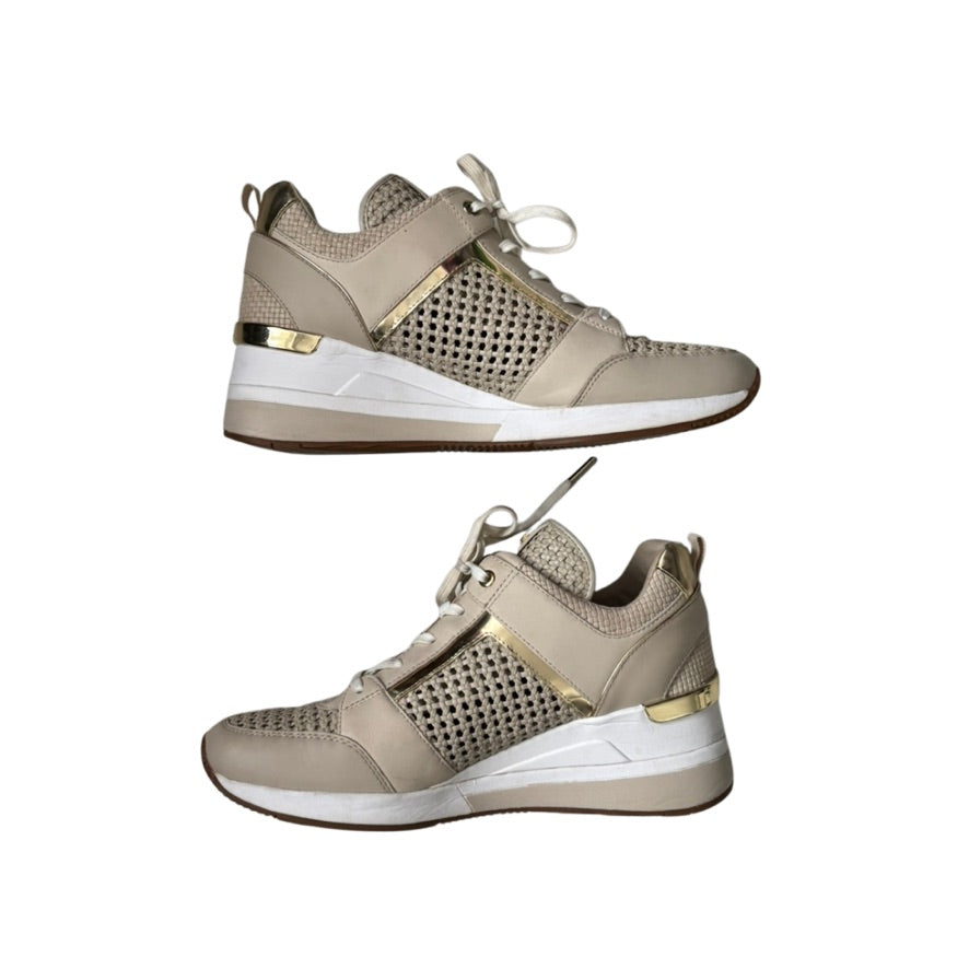 Beige sneakers with gold accents on a white background