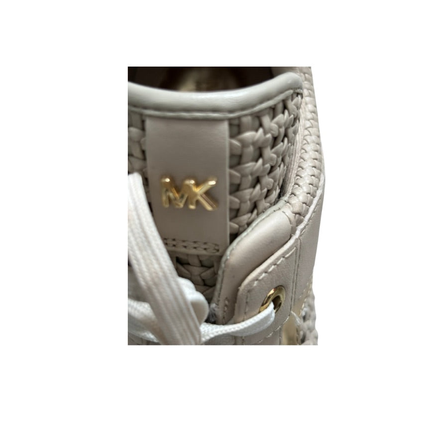 Close-up of a woven handbag with a gold logo on a white background