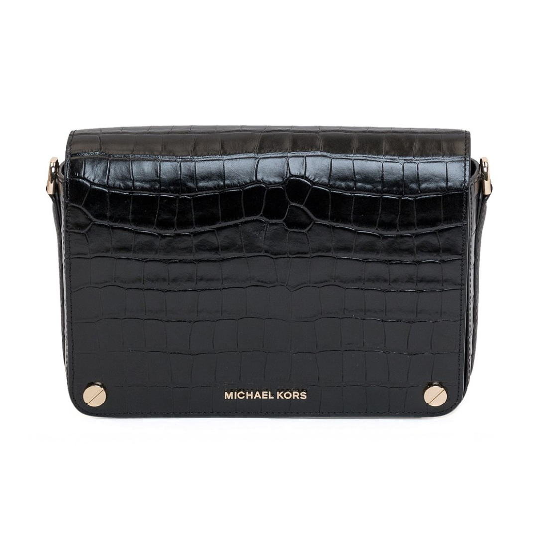 A black flap crossbody bag with embossed crocodile print and gold hardware, branded with 'MICHAEL KORS'.