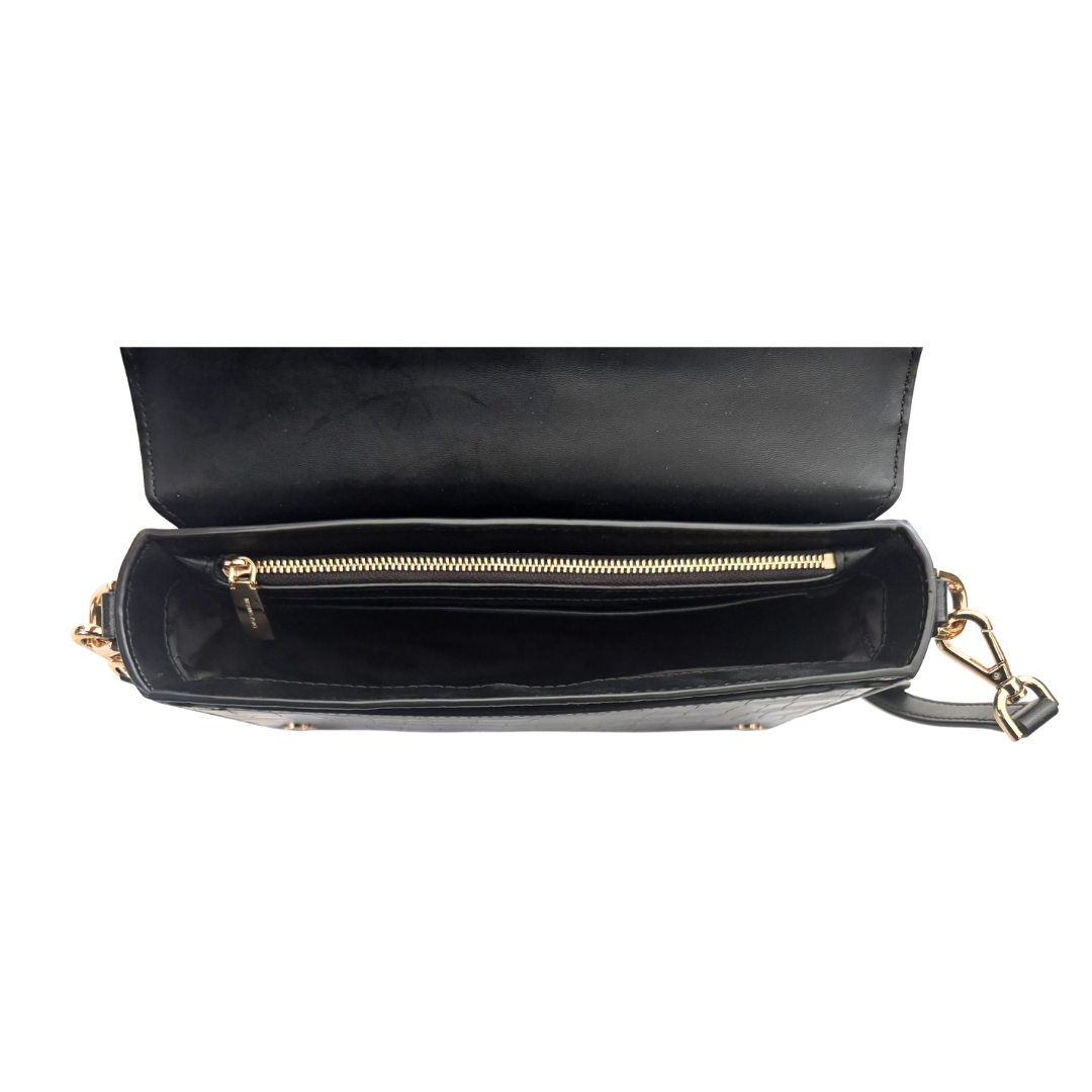 Black handbag with gold zipper and handle on a white background