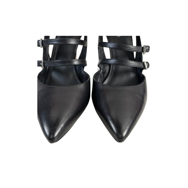 Pair of black pointed-toe shoes with strappy design on a white background
