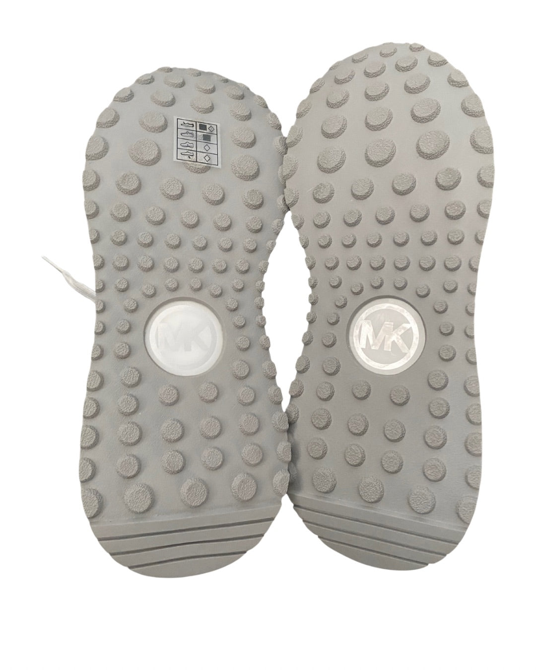 Gray shoe soles with textured surface and brand logo on a white background