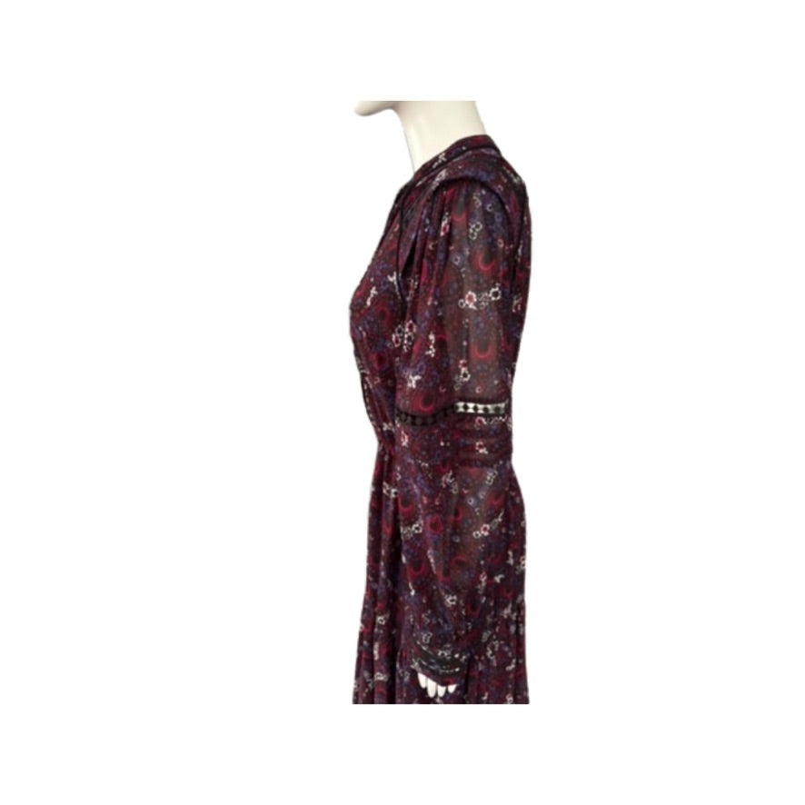 Mannequin wearing a burgundy dress with paisley pattern on a white background