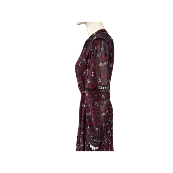 Mannequin wearing a burgundy dress with paisley pattern on a white background