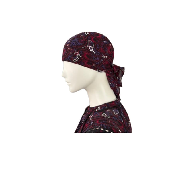 Paisley print headscarf on a mannequin head against a white background