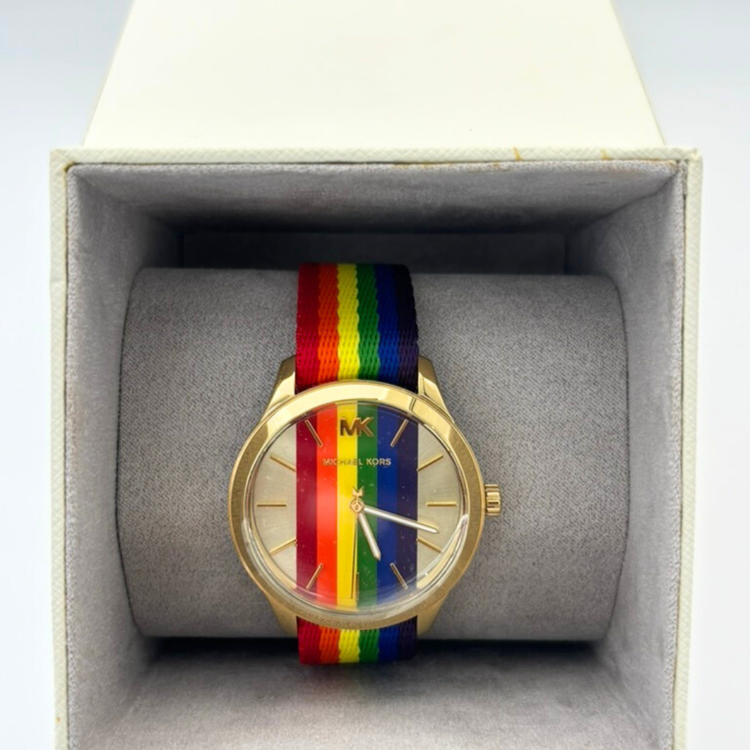 Gold watch with a rainbow strap in a box
