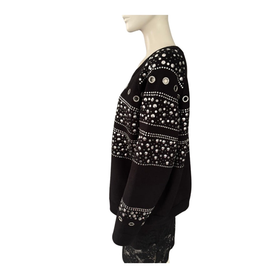 Black top with white embellishments on a mannequin against a white background