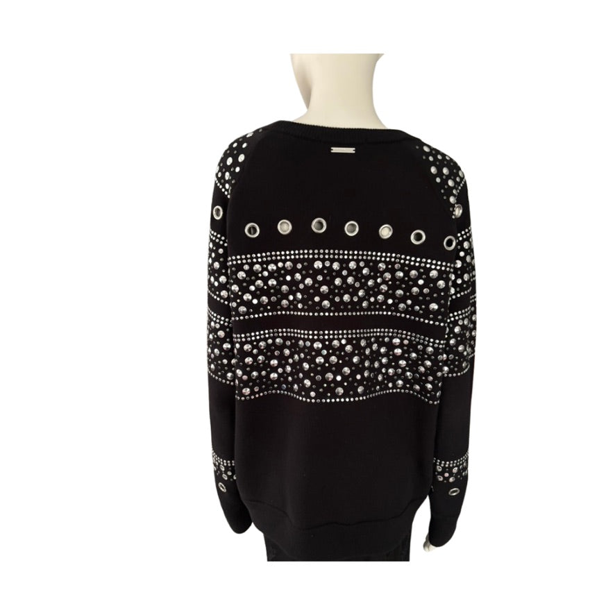 Black sweater with white bead patterns on a mannequin against a white background