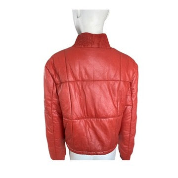 Orange leather jacket on a mannequin against a white background
