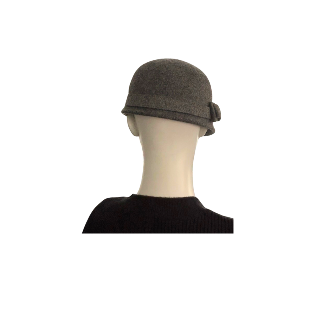 Grey cloche hat on a mannequin head against a white background
