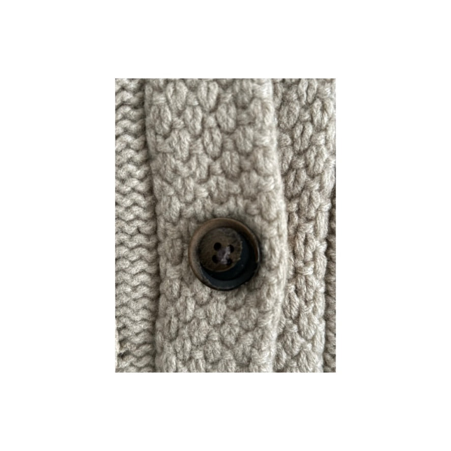 Close-up of a textured fabric with a button in the center on a white background