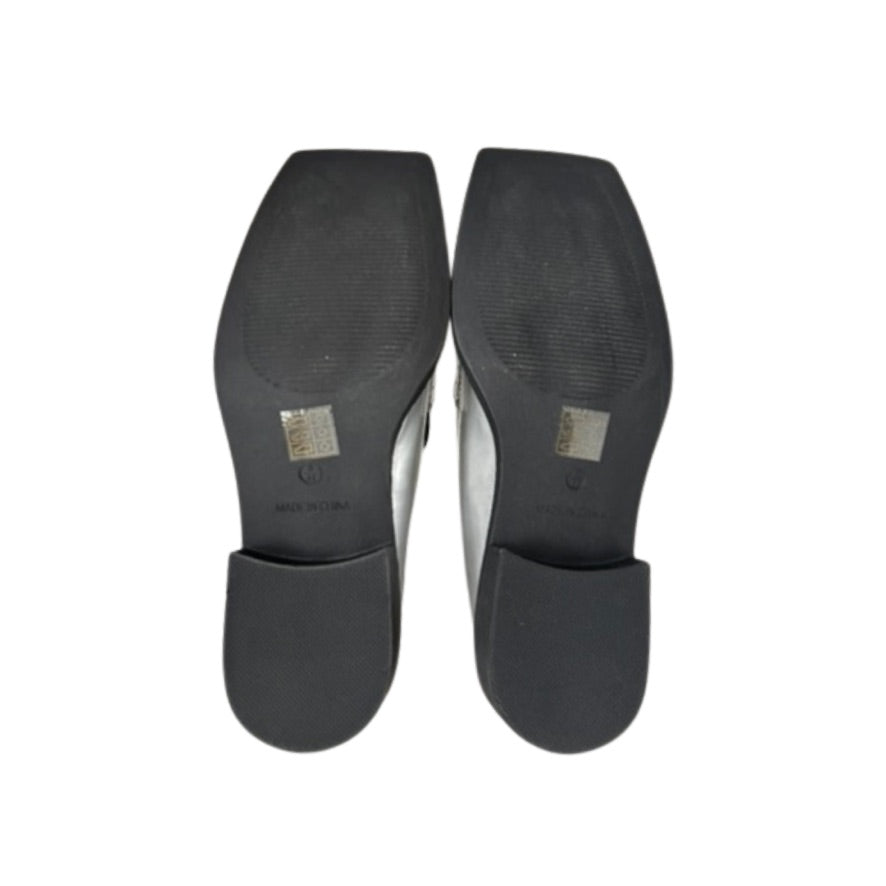 Black shoe insoles on a white background