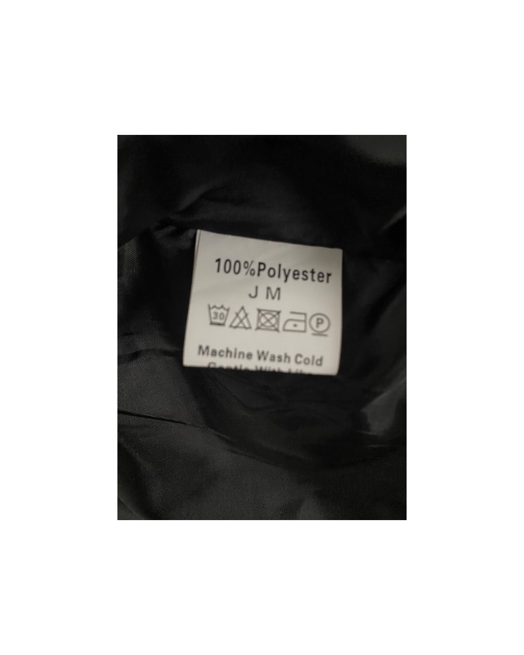 Clothing label on black fabric with washing instructions