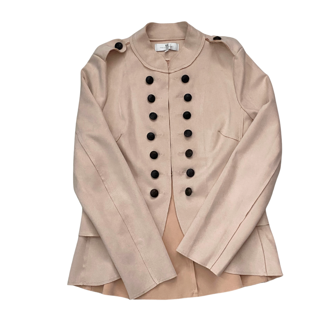 Pale pink jacket with black buttons on a white background