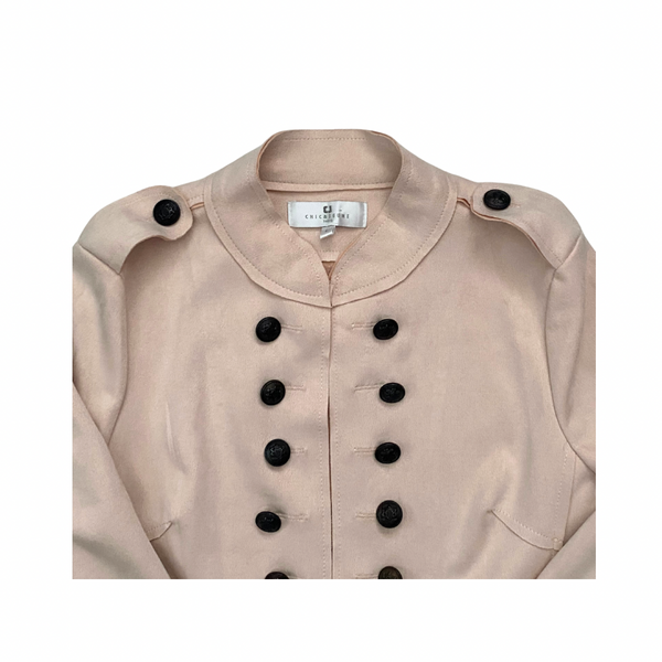 Pale pink jacket with black buttons on a white background