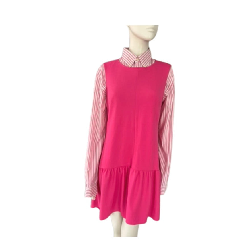 Mannequin wearing a pink dress with a striped shirt underneath on a white background