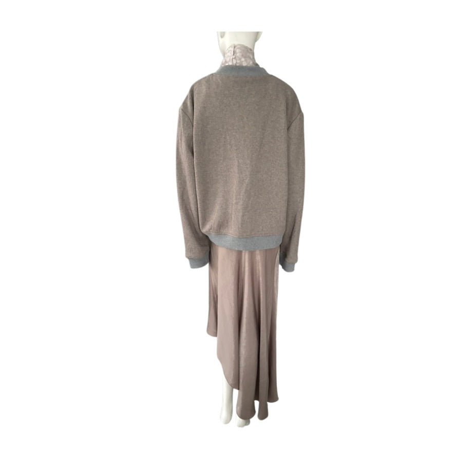 Mannequin wearing a gray sweater and beige skirt on a white background
