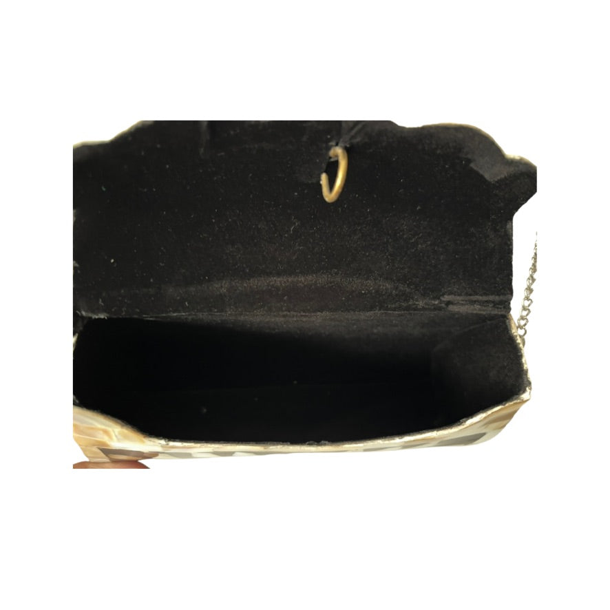Black clutch bag with gold chain on a white background