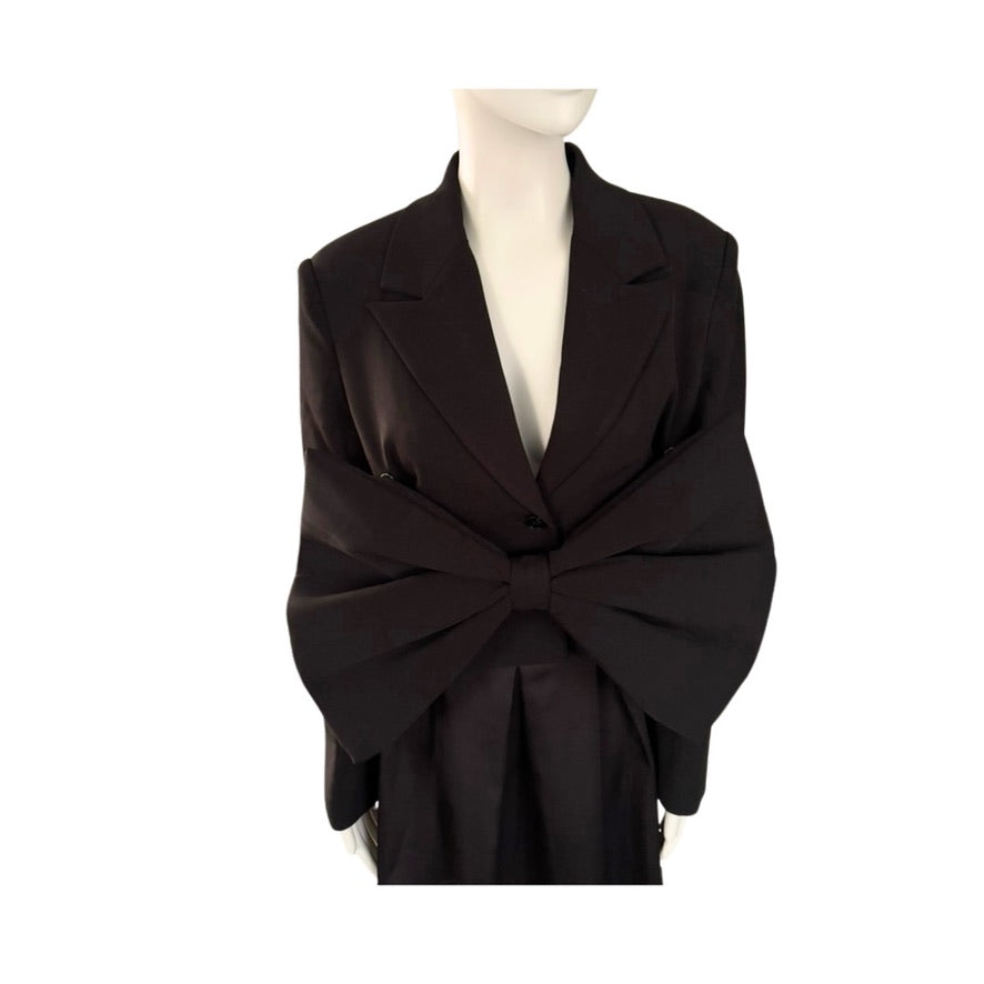 Black blazer with a large bow on a mannequin against a white background