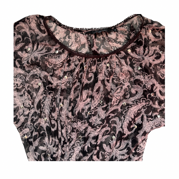 Black and pink floral patterned dress close-up on a white background