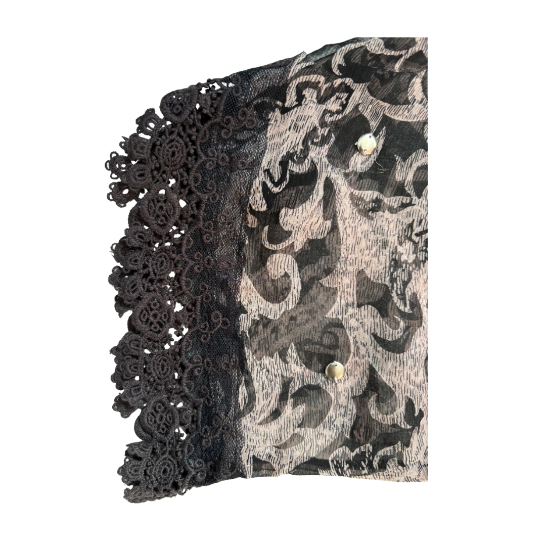 Black lace trim on a patterned fabric background