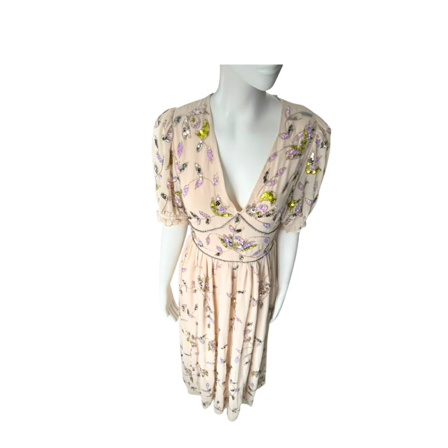 Floral dress on a mannequin against a white background