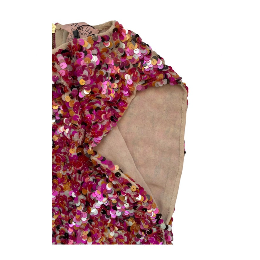 Multicolored sequin garment on a beige background