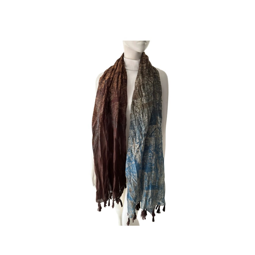 Mannequin wearing a brown and blue patterned scarf on a white background