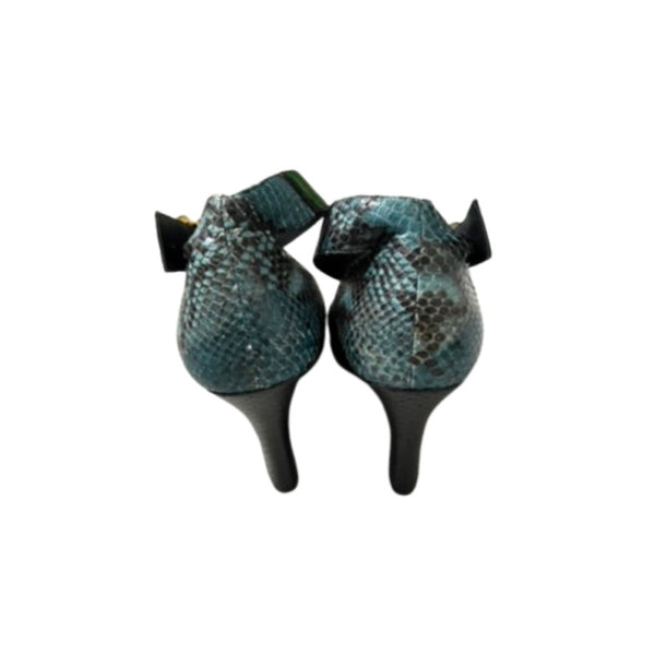 Pair of snake skin patterned boots on a white background