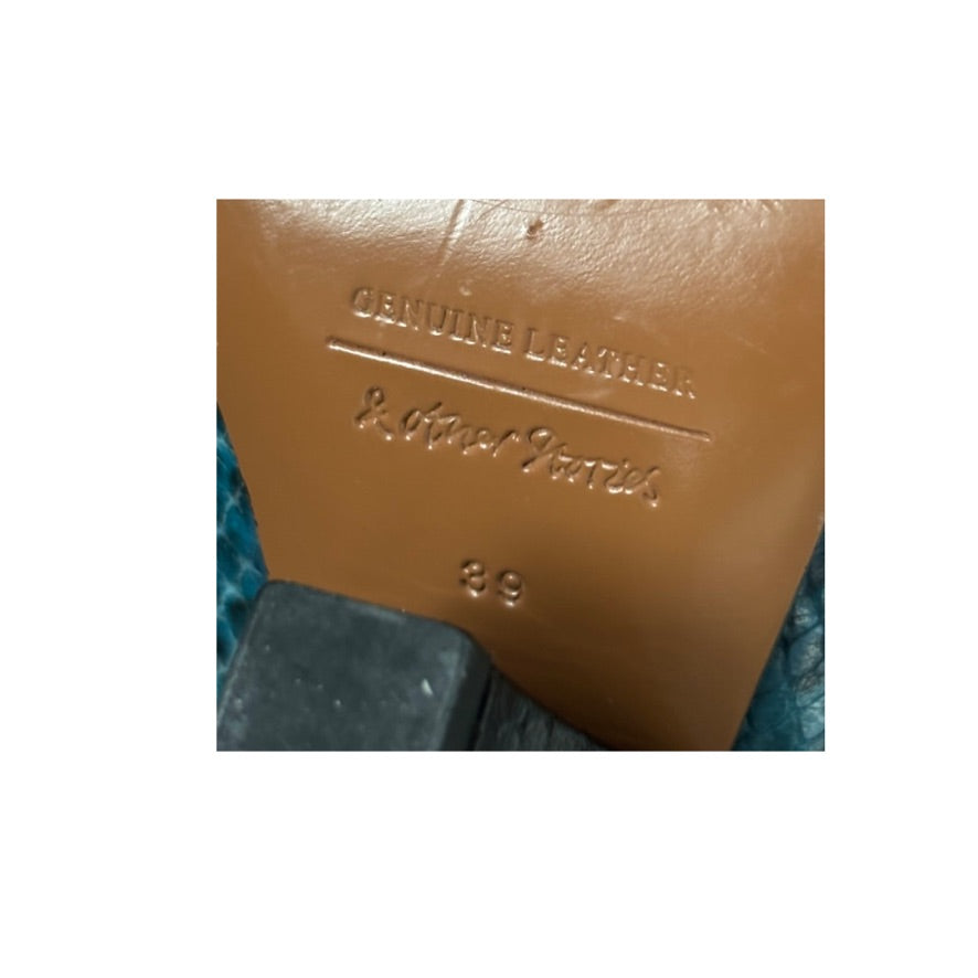Close-up of a brown leather label with text on a white background