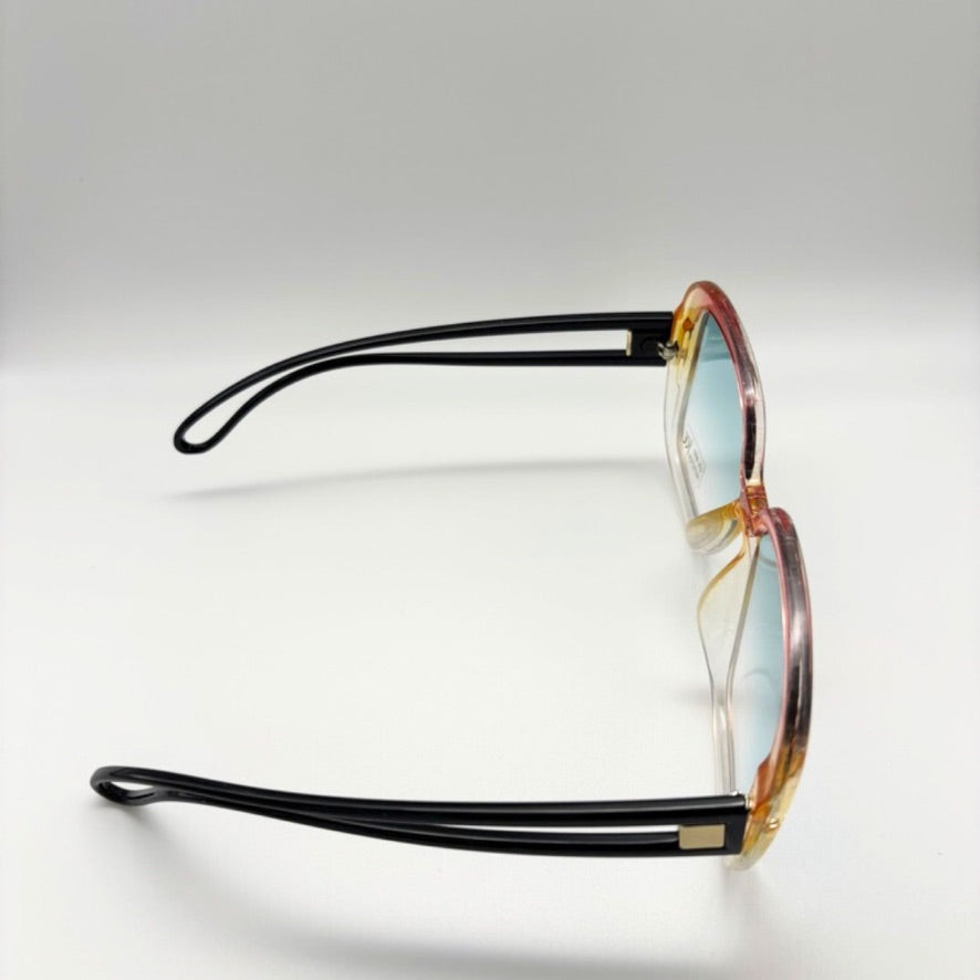 Sunglasses with black frame and multicolored lenses on a light gray background