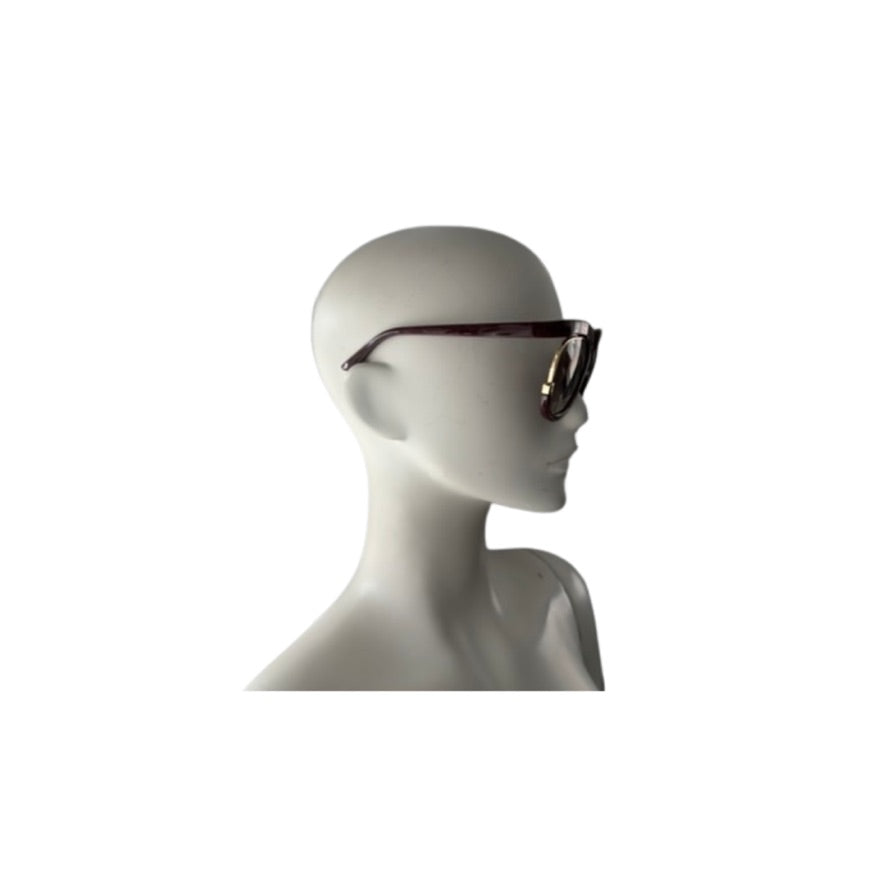 Mannequin head wearing a pair of sunglasses on a white background