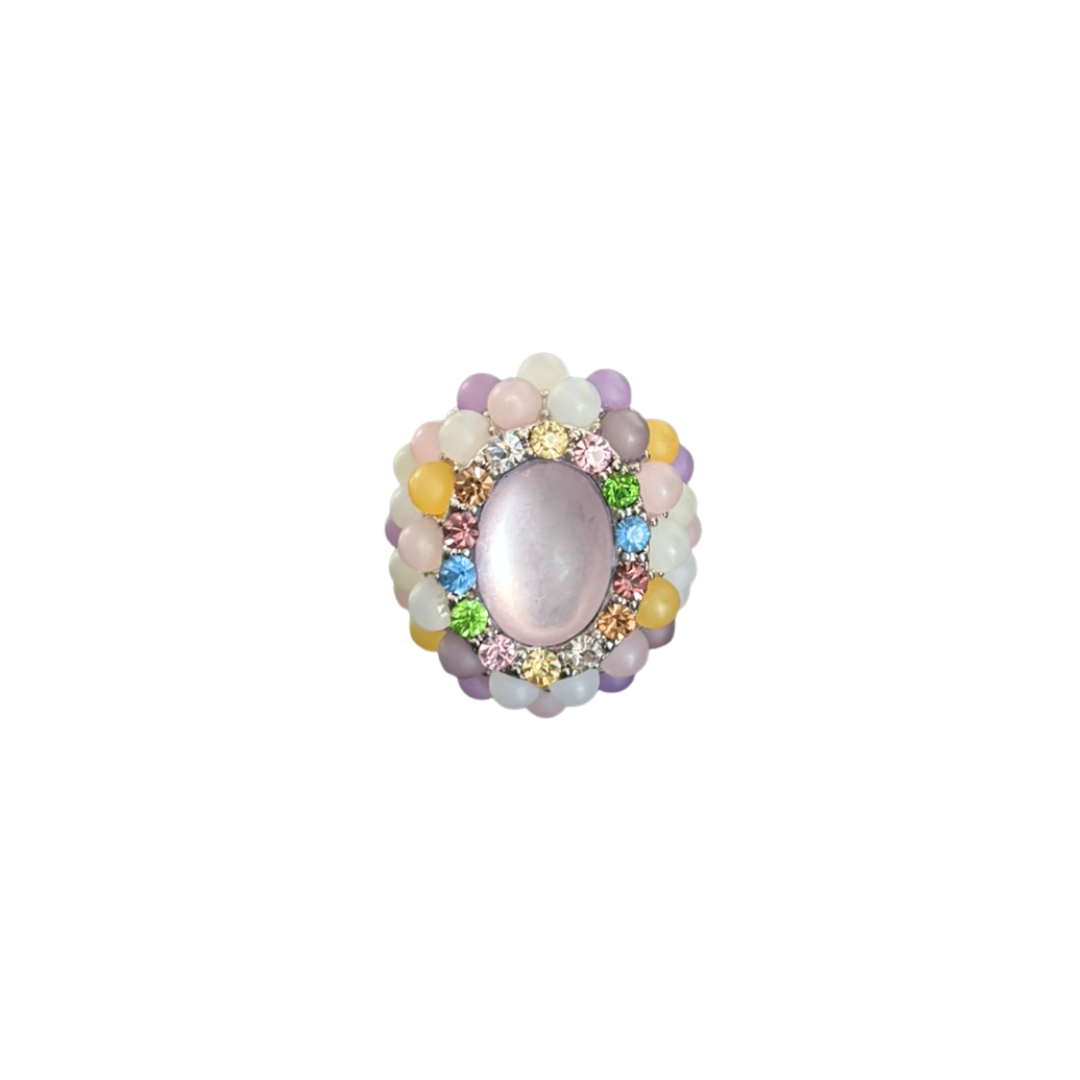 Decorative ring with colorful gemstones on a white background