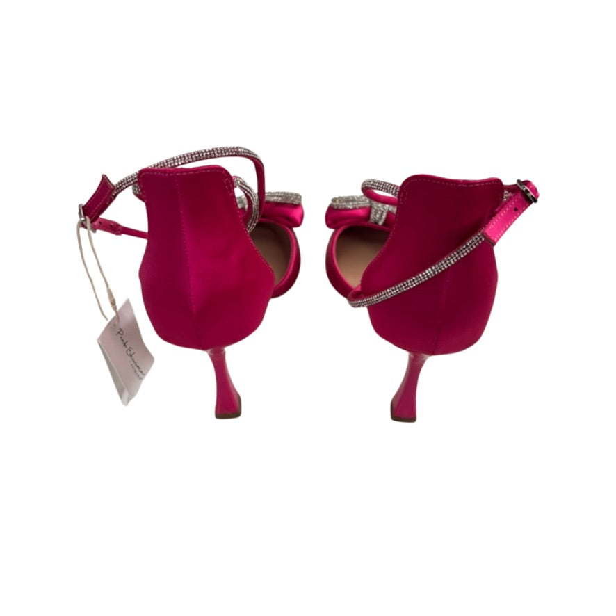 Pair of pink high-heeled shoes with rhinestone straps on a white background