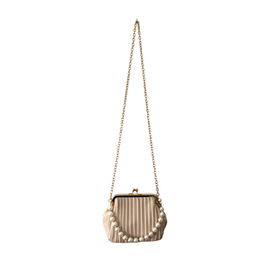Ribbed handbag with pearl embellishments on a white background