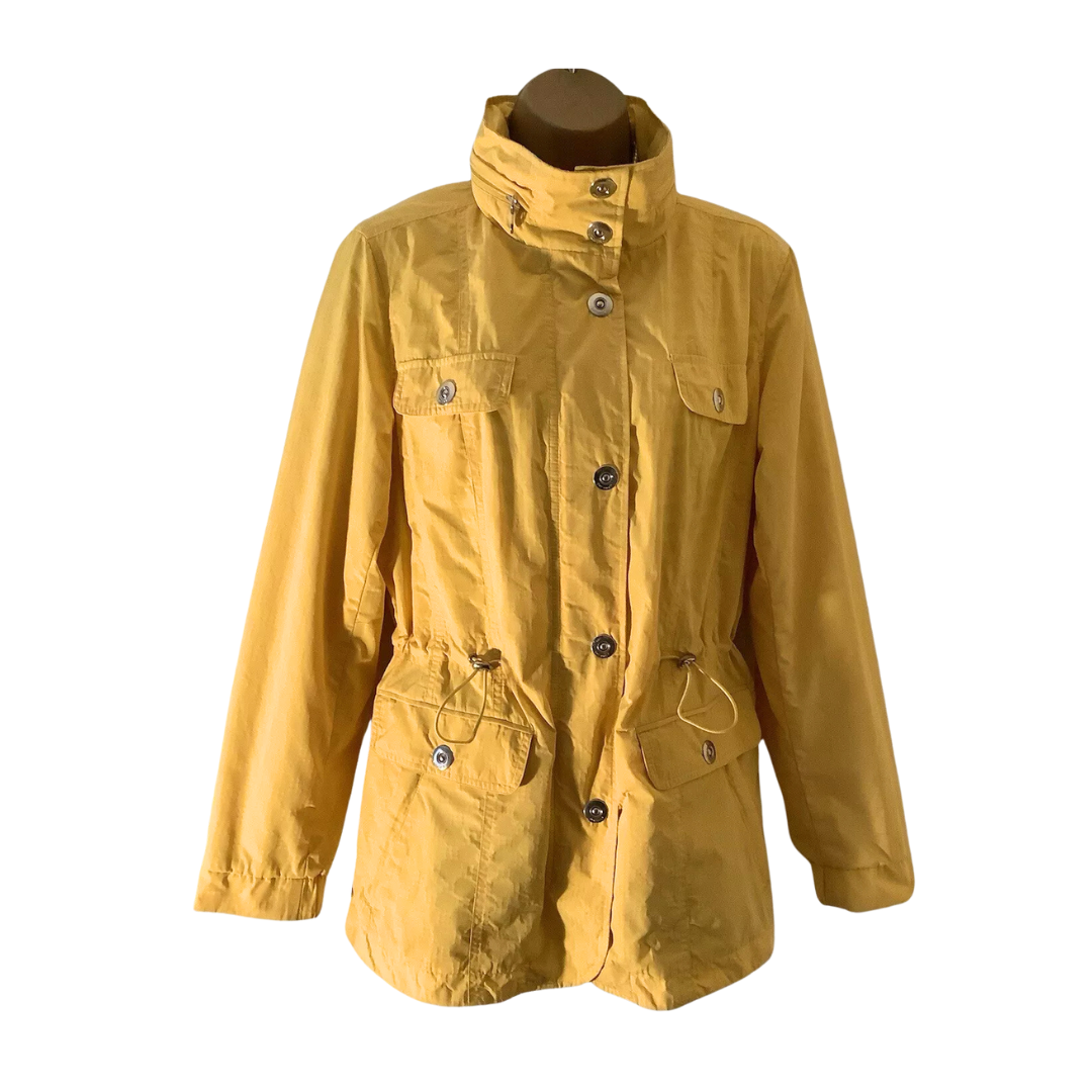 Yellow raincoat on a mannequin against a white background