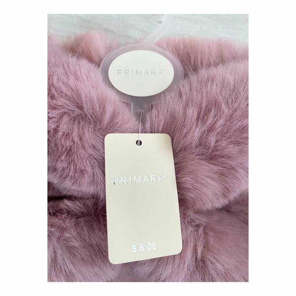 Pink faux fur product with a 'PRIMARK' price tag on a white background
