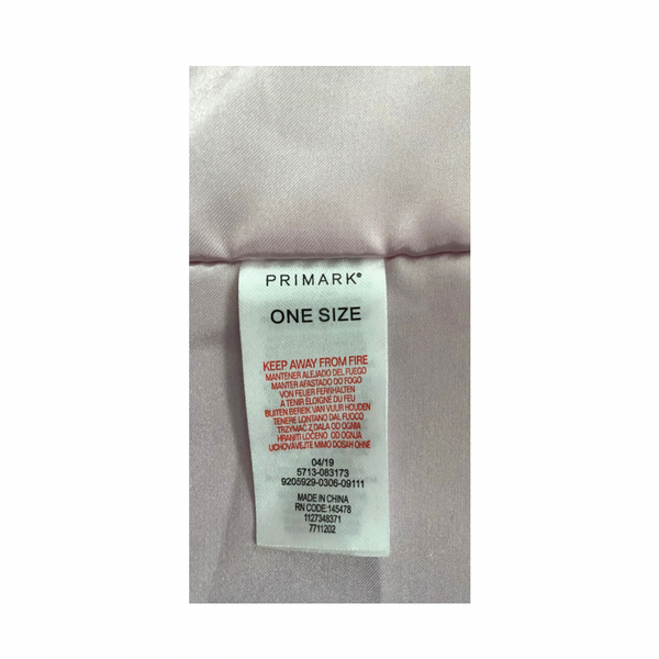 Close-up of a Primark label on a garment with text and product details.