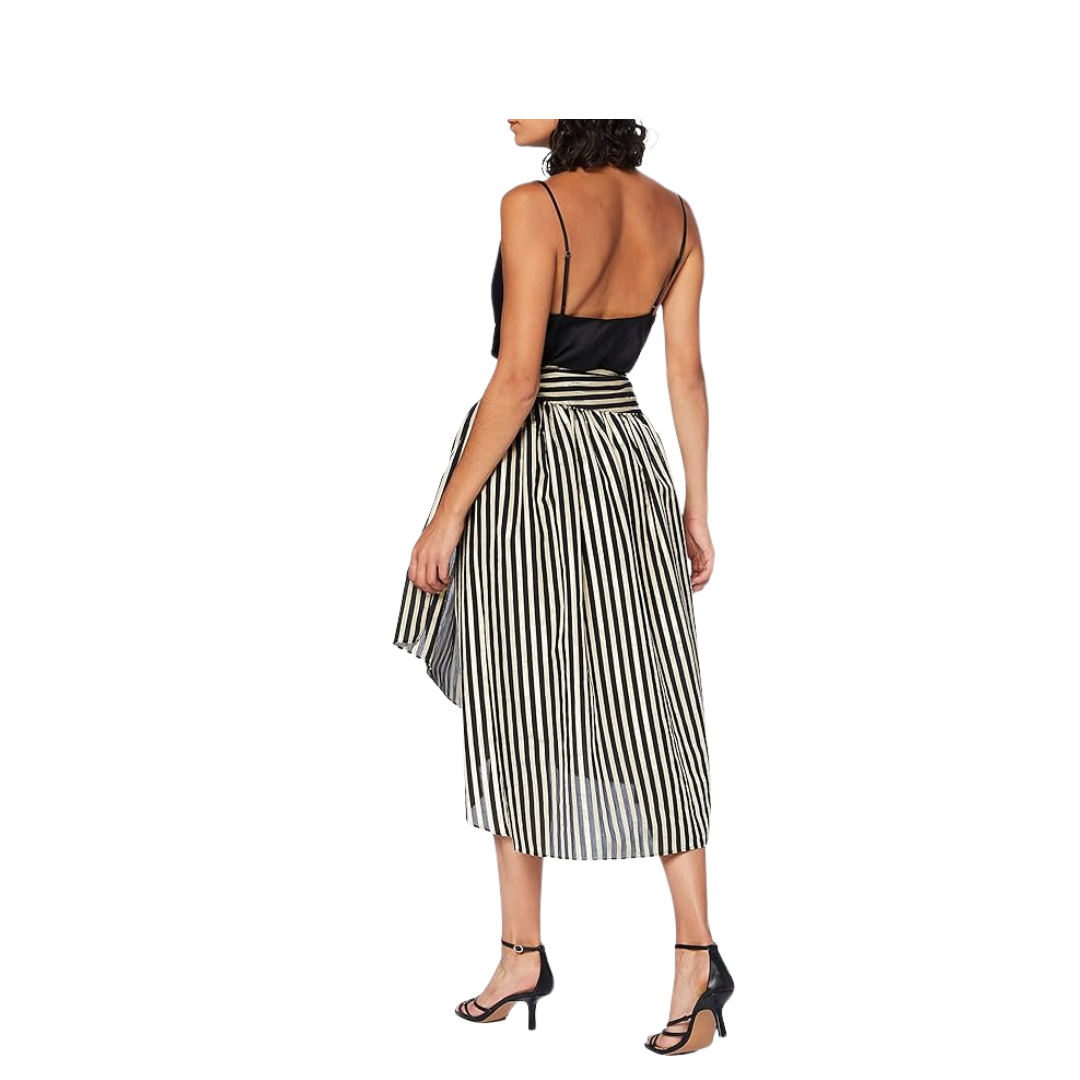 Woman wearing a black and white striped dress on a white background