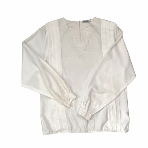 White blouse with lace details on a white background