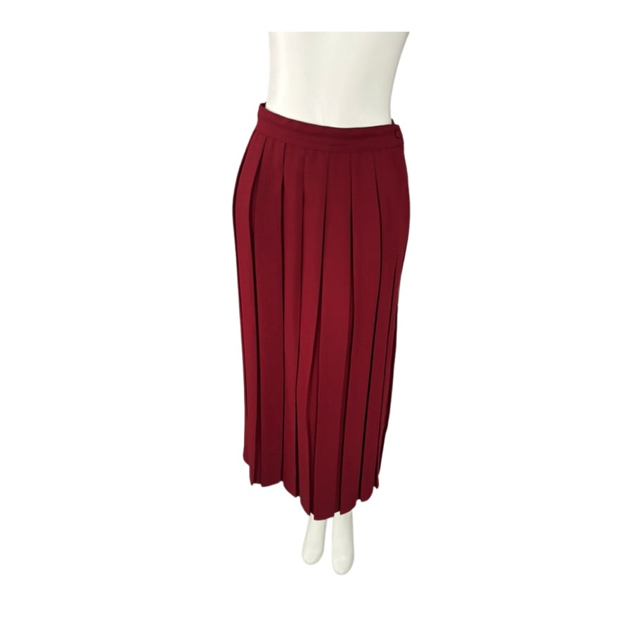 Red pleated skirt on a mannequin against a white background