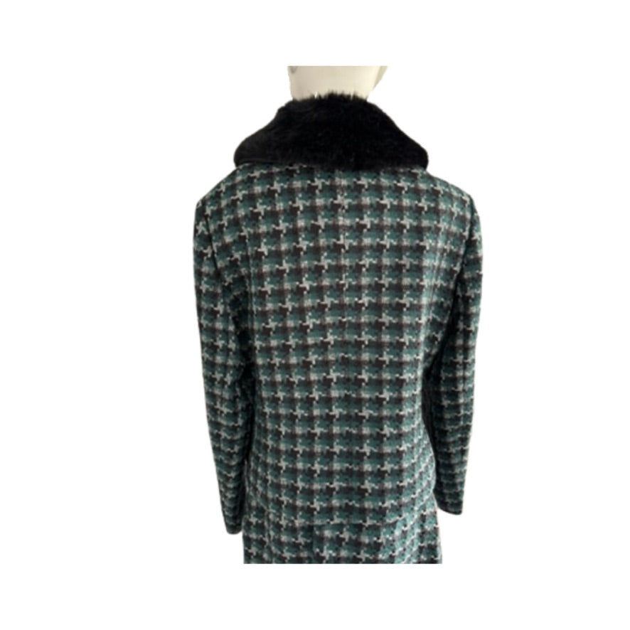 Houndstooth pattern coat with black fur collar on a mannequin against a white background